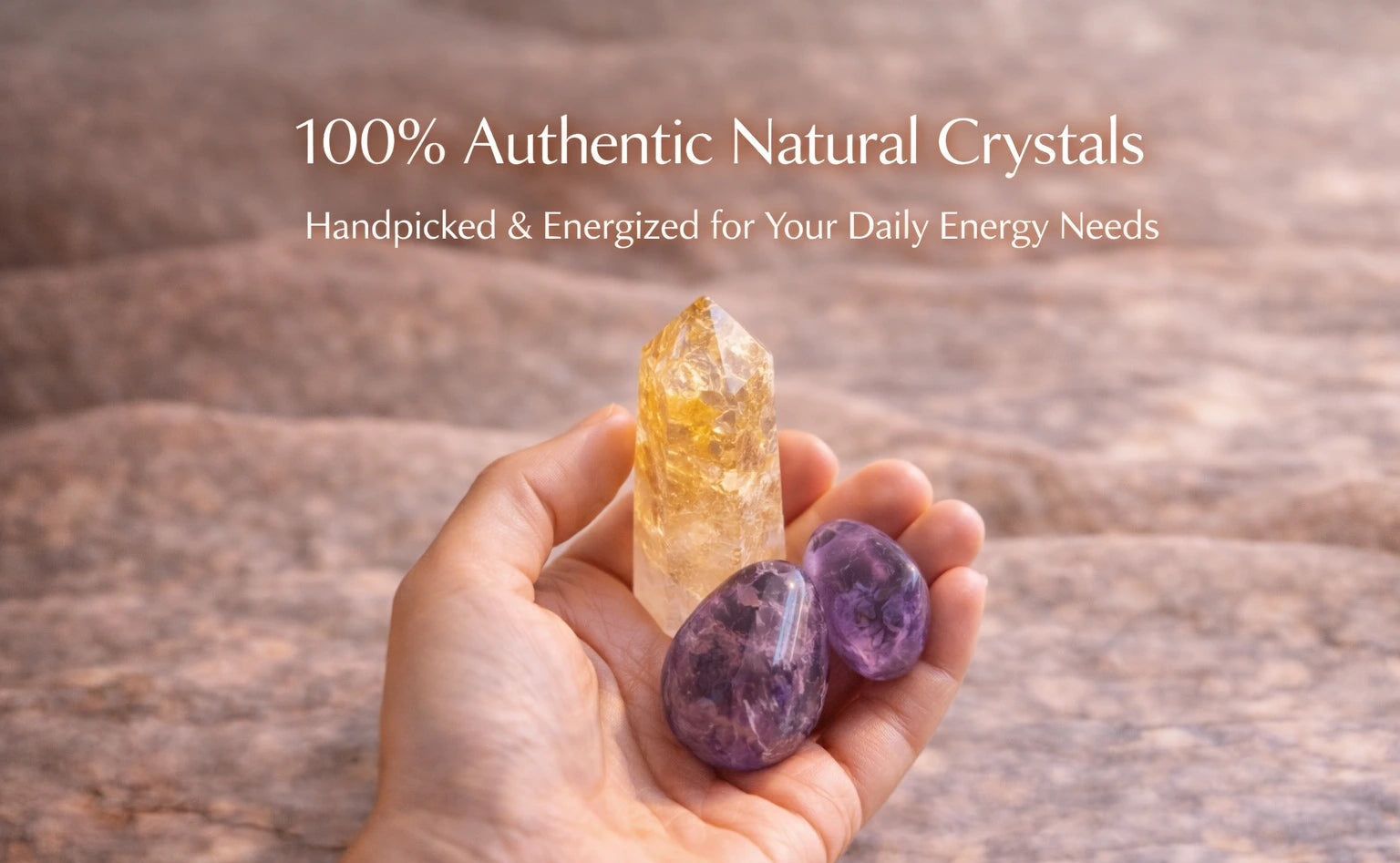 Close-up of hand holding citrine point and amethyst tumble stones with natural texture in soft warm lighting