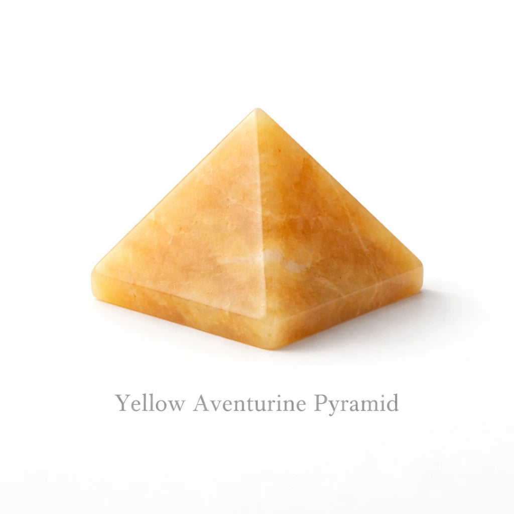 Yellow aventurine crystal pyramid placed on white background polished healing stone for wealth confidence and positivity